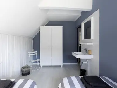 a bedroom with a white cabinet and a sink at Farmhouse in Groet near sea and forest in Groet