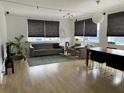 a living room with a couch and a table at Apartments Zaanse Schans and Amsterdam in Wormer
