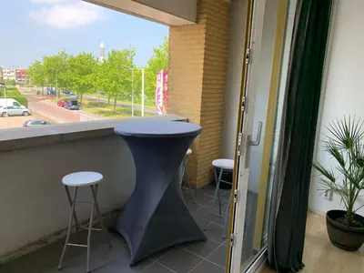 a bar in a balcony with stools and a window at Apartments Zaanse Schans and Amsterdam in Wormer