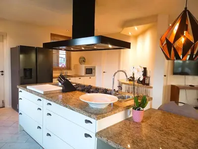 a kitchen with a counter top with a sink at Villa Pura Vida in Oud-Ade
