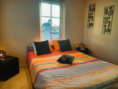 a bed in a room with a window at Villa Pura Vida in Oud-Ade