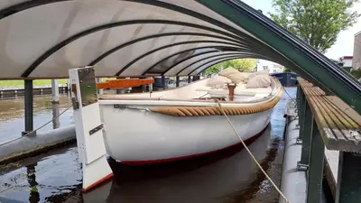 a boat is docked under a bridge at Villa Pura Vida in Oud-Ade