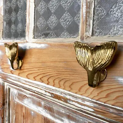 a wooden door with brass handles on a wooden door at Fabel aan Zee in Zandvoort