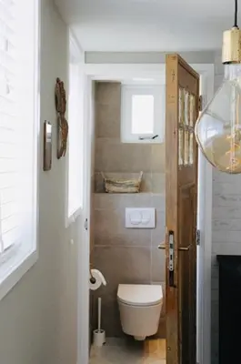 a small bathroom with a toilet and a window at Fabel aan Zee in Zandvoort