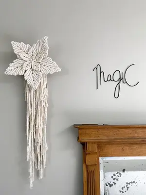 a dream catcher hanging on a wall next to a fireplace at Fabel aan Zee in Zandvoort
