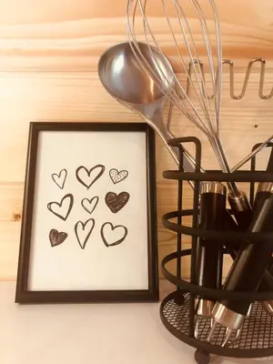 a picture of hearts in a frame next to a whisk at LODGE 5 Zandvoort in Zandvoort