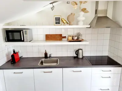 a kitchen with a sink and a microwave at ''Op Stok