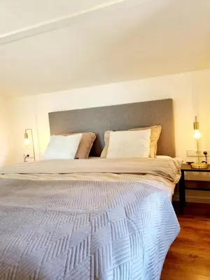 a bedroom with a large white bed with two pillows at ''Op Stok