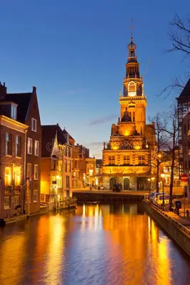 a building with a clock tower next to a river at ''Op Stok