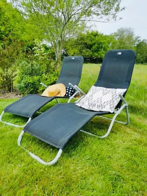 two chairs sitting in the grass in a field at ''Op Stok