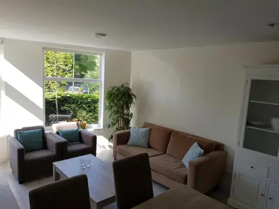 a living room with a couch and chairs and a table at Villa Amsteldijck (8km from Amsterdam) in Ouderkerk aan de Amstel