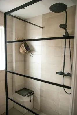 a walk in shower with glass shelves in a bathroom at huisje de Strandjutter in Katwijk aan Zee