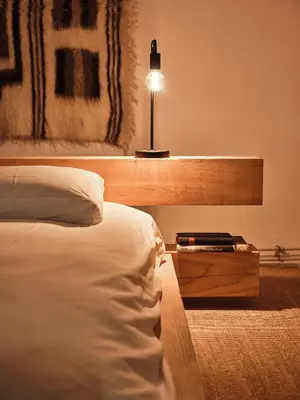 a bedroom with a bed and a table with a lamp at Eco Hotel Plantage Rococo in Velsen-Zuid