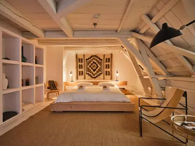 a bedroom with a bed and a wooden ceiling at Eco Hotel Plantage Rococo in Velsen-Zuid