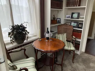 a room with a table and two chairs and a window at B&B 't Raethuys in Dirkshorn