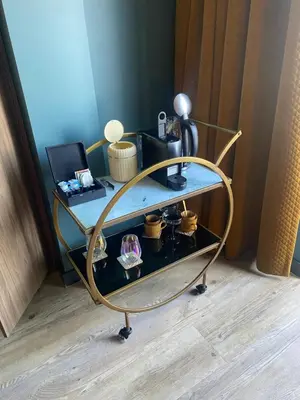 a glass and metal cart with a glass table at The Rock in Zandvoort