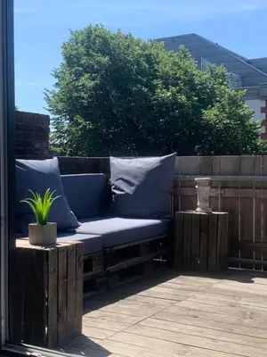 a blue couch sitting on top of a patio at The Rock in Zandvoort