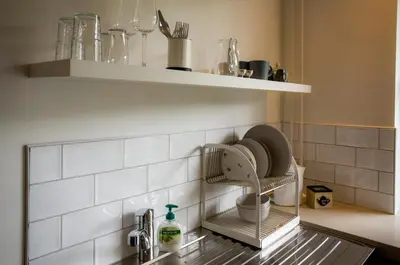 a kitchen with a sink with a faucet at Slapen bij Jesse in Broek in Waterland