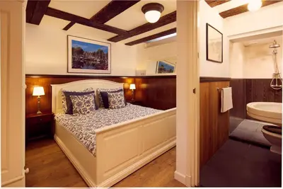 a bedroom with a bed and a bathroom with a tub at Realeneiland Bed & Breakfast in Amsterdam