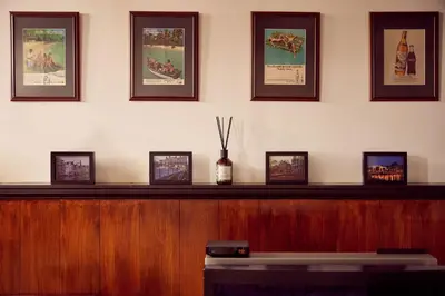 a wooden partition with framed pictures on a wall at Realeneiland Bed & Breakfast in Amsterdam
