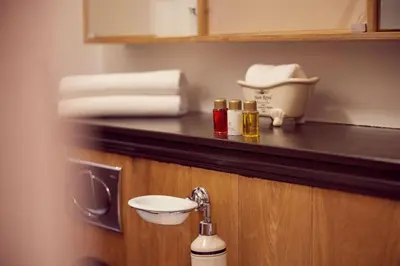 a bathroom with a sink and a counter with towels at Realeneiland Bed & Breakfast in Amsterdam