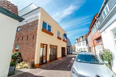 a car parked in front of a building at Sunny Spacious Apartment De Bijenkorf in Zandvoort