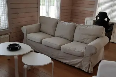 a living room with a couch and two tables at The Blue House - Luxurious Waterfront Villa Zeewolde in Zeewolde