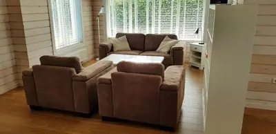 a living room with a couch and two chairs at The Blue House - Luxurious Waterfront Villa Zeewolde in Zeewolde
