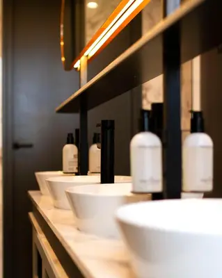 a row of white sinks in a bathroom at THIS HO(S)TEL in Amsterdam