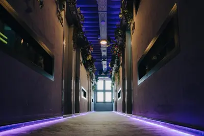 an empty hallway in a building with purple lights at THIS HO(S)TEL in Amsterdam