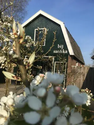 a barn with a sign on the side of it at bij San & Ka in Hauwert