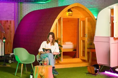 a woman sitting on a chair in a play house at Outside Inn in Amsterdam