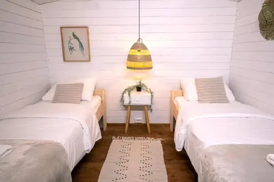 two beds in a room with white walls at Outside Inn in Amsterdam