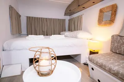 a bedroom with two beds and a table with a lamp at Outside Inn in Amsterdam