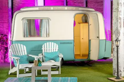 a room with two chairs and a caravan at Outside Inn in Amsterdam
