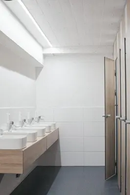 a bathroom with three sinks and two mirrors at Outside Inn in Amsterdam