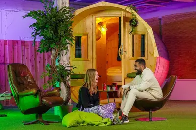a man and a woman sitting in front of a house at Outside Inn in Amsterdam