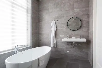 a bathroom with a tub and a sink and a mirror at Anegang Boutique Appartement in Haarlem