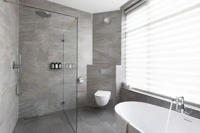 a bathroom with a shower and a toilet and a sink at Anegang Boutique Appartement in Haarlem