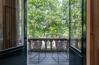 an open door to a porch with two chairs at Utrecht City Apartments - Maliesingel in Utrecht