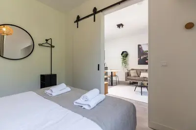 a bedroom with a bed with two towels at Utrecht City Apartments - Maliesingel in Utrecht