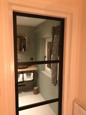 a mirror in a bathroom with a sink at Long Beach Rooms Zandvoort in Zandvoort
