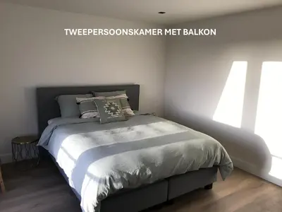 a bedroom with a bed in a room at Long Beach Rooms Zandvoort in Zandvoort