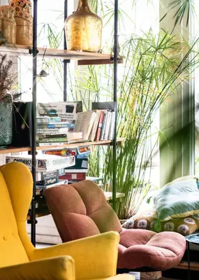 a living room with two yellow chairs and plants at Zwier, de Vrijhaven in Vinkeveen