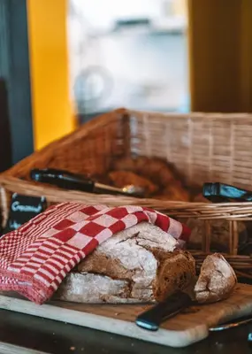 a loaf of bread and a basket with a napkin at Zwier, de Vrijhaven in Vinkeveen