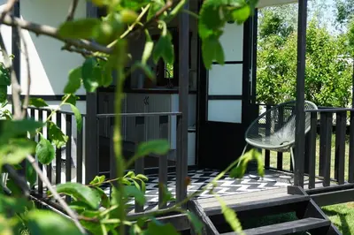 a porch with two chairs and a table at Camping de Vliert in Bunnik