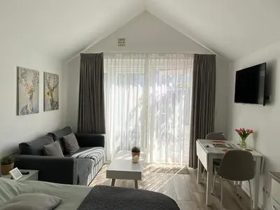 a living room with a couch and a table at Het Krabbehuisje in Zandvoort