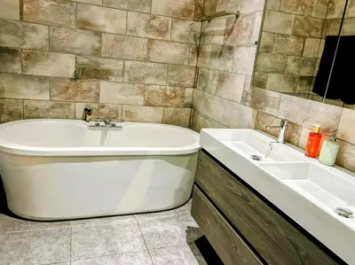 a bathroom with a tub and a sink at Marijke's guestroom in Amsterdam