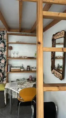 a room with a bed with a table and a mirror at Marijke's guestroom in Amsterdam