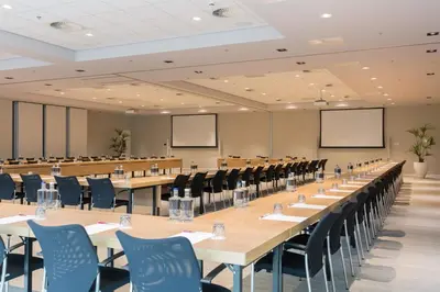 a large conference room with tables and chairs at Crowne Plaza Utrecht - Central Station by IHG in Utrecht